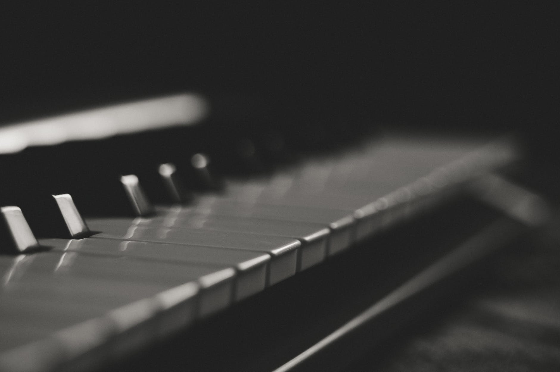 dark close up on piano keys forced perspective black and white