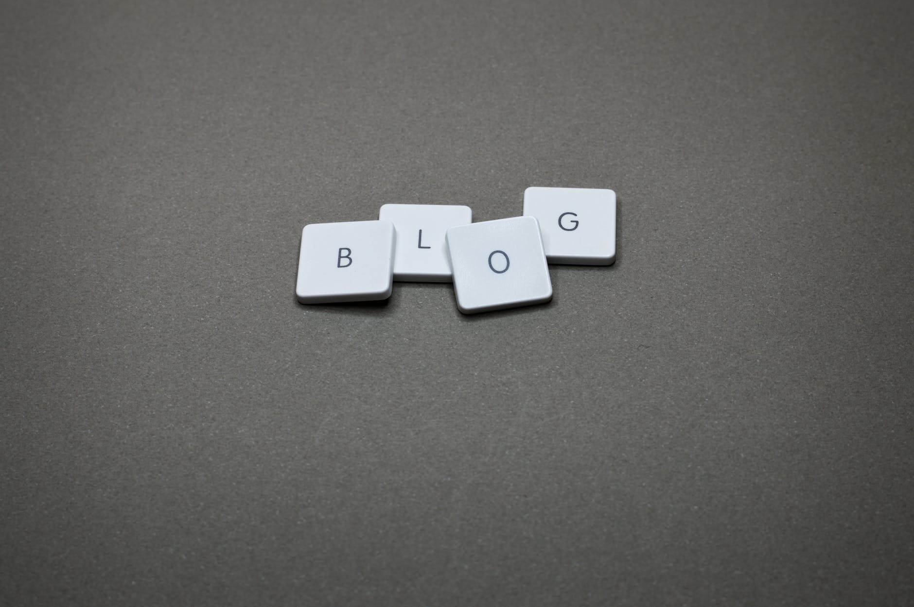 letter tiles spelling out blog on a flat gray surface
