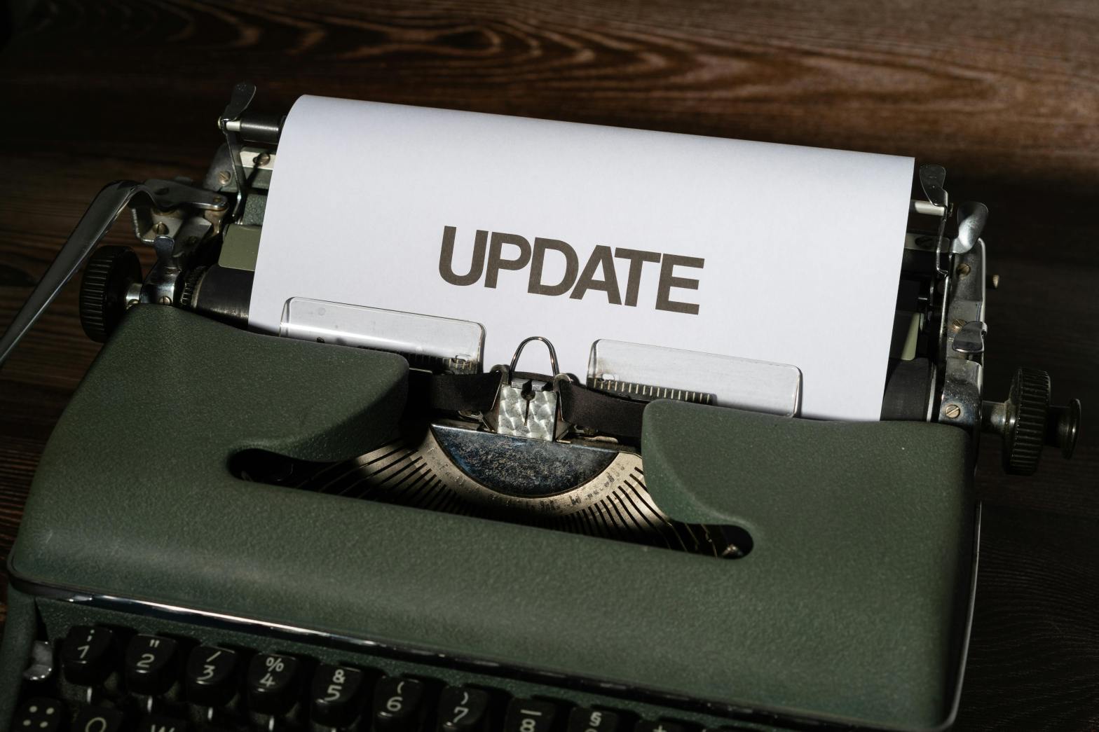 typewriter with a piece of paper inside that says Update