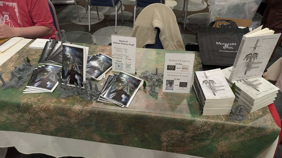 books set up with fantasy tabletop rpg miniatures